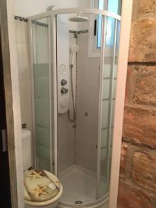 a glass shower in a bathroom with a toilet at Casa Maria in Rota