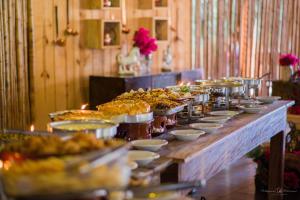 a buffet line with many plates of food on at Cliv Sol in Patrimônio Jaguaretê