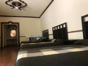 En eller flere senger på et rom på La Ilusión Hotel Campestre y Balneario