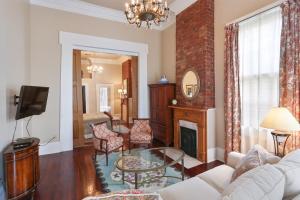 a living room with a couch and a fireplace at Elysian Fields Inn in New Orleans