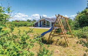 a wooden ladder in a yard with a house at Amazing Home In Slagelse With Kitchen in Slagelse +17 photos