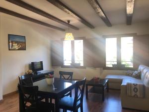 a living room with a table and a couch at Casa de Navalhorno Valsain in La Pradera de Navalhorno