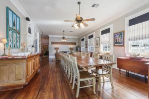 a dining room with a wooden table and chairs at Elysian Fields Inn in New Orleans