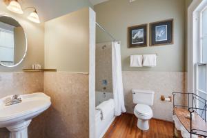 a bathroom with a sink and a toilet and a mirror at Elysian Fields Inn in New Orleans +17 photos