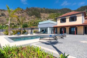 a villa with a swimming pool and a house at Casa Mariana by Rent2U, Lda in Arco da Calheta