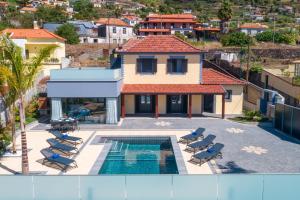 an aerial view of a house with a swimming pool at Casa Mariana by Rent2U, Lda in Arco da Calheta