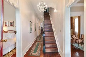 a staircase in a home with a chandelier at Elysian Fields Inn in New Orleans