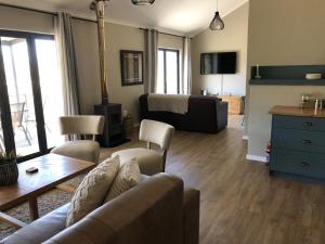 a living room with a couch and a table at Lola's Self Catering Accommodation in Clarens