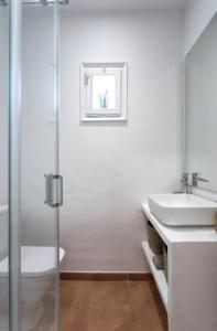 a white bathroom with a sink and a shower at Can Terrats in Blanes