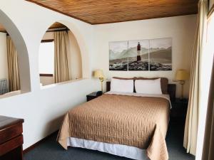 a hotel room with a bed and a lighthouse at Hotel Ushuaia in Ushuaia