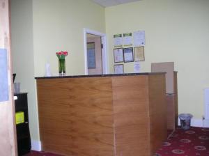 a large wooden door in a room with flowers on the wall at The Belvedere in Blackpool
