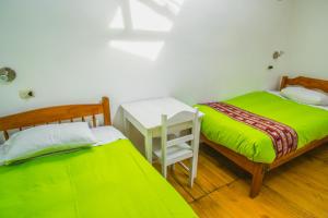 Postel nebo postele na pokoji v ubytování Tucan Hostel