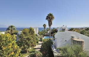 an aerial view of a resort with a pool and palm trees at Paris Village Apartments in Chrani