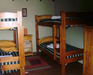 a room with three bunk beds in a room at Rocío de Luz in San Clemente del Tuyú