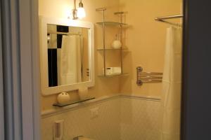 uma casa de banho com um espelho e um lavatório em B&B Giorno e Notte em Pisa