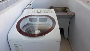 a washing machine with a red circle on top of it at Edifício Belio in Cascavel