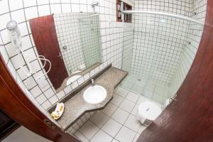 a bathroom with a sink and a mirror at Hotel Pousada Da Sereia in Maceió