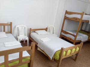 a room with three bunk beds and a ladder at Hospedaje Daniel's House, by Carlos & Patricia in Paracas