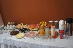 a table with food and drinks on a table at Pousada das Gaivotas in Bombinhas