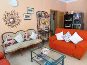 a living room with two couches and a table at Hotel Goartín in Málaga