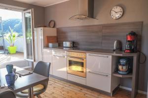 a kitchen with an oven and a table and a table and chairs at Feriendomizil "Alte Post" II in Pronsfeld
