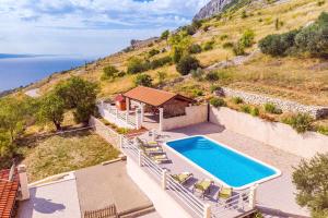 an aerial view of a house with a swimming pool at VILLA MASLINA, with private 32m2Pool, panoramic views on 100km coastline, 12 pax in Lokva Rogoznica