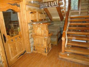 a wooden cabin with a staircase in a room at Drin-lux-cotteges in Slavske