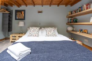 a bedroom with a large bed with a blue blanket at Old Coach House - "Loved staying here" in Sheffield