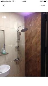 a shower in a bathroom with a sink at Уютная квартира около станции метро in Yerevan +6 photos
