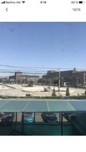 a tennis court with cars parked in a parking lot at Уютная квартира около станции метро in Yerevan