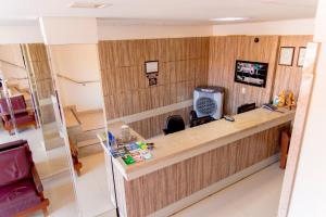 an office with a long counter with a desk at Bougainville Barreiras in Barreiras
