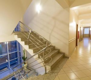 a spiral staircase in a building with a hallway at Bellmont Hotel in Concordia