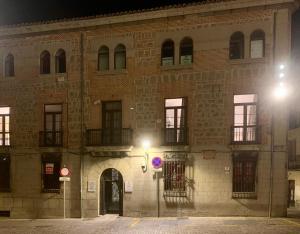 a large brick building with a street light in front at Santa Suites in Avila