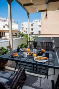 una mesa con platos de comida en el patio en So Close!, en Agios Nikolaos