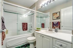 a bathroom with a tub and a toilet and a sink at Town Plaza Suites by Golden Dreams in Whistler +36 photos