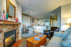 a living room with a couch and a fireplace at Town Plaza Suites by Golden Dreams in Whistler