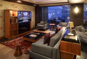 a living room with a couch and a television at JW Marriott Hotel Mexico City Santa Fe in Mexico City