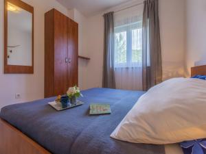 a bedroom with a bed with a tray of flowers on it at Apartments Rabbit in Crikvenica