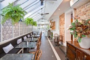 a row of tables and chairs in a restaurant at The Hughenden Boutique Hotel in Sydney