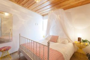 a bedroom with a bed with a mosquito net at Alfama Charming Apt with 2 Free Bikes By TimeCooler in Lisbon