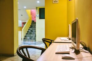 a desk with two computer monitors and a keyboard at Hotel Boutique Casa Abuela Maria in Oaxaca City
