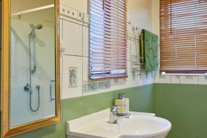 a bathroom with a sink and a shower and a mirror at Coastal, Spacious, Mountain Views - KK21238 in Kaikoura