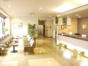 een lobby van een ziekenhuis met stoelen en tafels bij Hotel Route-Inn Gifukencho Minami in Gifu