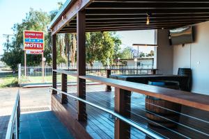 
a wooden bench in front of a restaurant at Copper City Motel in Cobar
