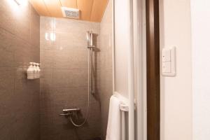 a bathroom with a shower with a toilet and a sink at La Plagne in Kutchan +19 photos