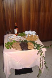 a table with a plate of food and a bottle of wine at Hotel Signorini in Castiglioncello