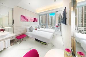 a bedroom with a bed and a sink and a mirror at iclub Mong Kok Hotel in Hong Kong