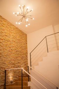 a staircase with a brick wall and a chandelier at Muralla suite 320. Habana Vieja in Havana