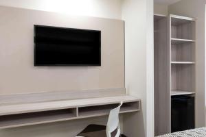 a room with a desk and a television at Microtel Inn & Suites by Wyndham Atlanta Buckhead Area in Atlanta
