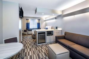 a small hotel room with a couch and a table at Microtel Inn & Suites by Wyndham Atlanta Buckhead Area in Atlanta
